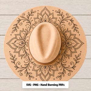 May include: A tan felt hat featuring a black line art mandala design on the brim, with a central crown and a matching tan hat band. The image includes the text SVG • PNG • Hand Burning PDFs at the bottom, indicating digital file formats.