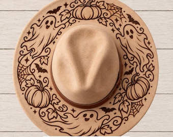 May include: A tan felt hat featuring a dark brown laser-engraved design of ghosts, pumpkins, bats, and spiderwebs around the brim. The text "SVG • PNG • Hand Burning PDFs" is printed in a white rectangular box at the bottom of the image.