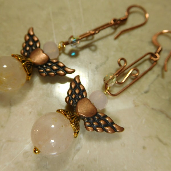Rose quartz angel wings earrings hanging from copper tone clip, fishing hook earrings. #E00332