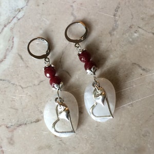 White quartz earrings with decorative silver tone hearts, faceted garnet stone beads and stainless steel lever back earrings. #E00342