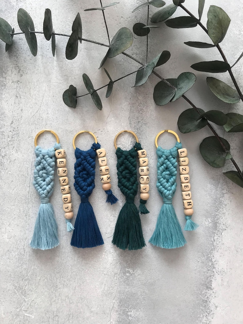 Personalized macramé keychains hand-woven from pure cotton cord. Available in a wide range of colors and featuring wooden bead accents, these keychains make a lovely gift for bridesmaids, the maid or matron of honor, flower girls, and the "bride tribe." They also add an elegant touch to bridesmaid proposal boxes.