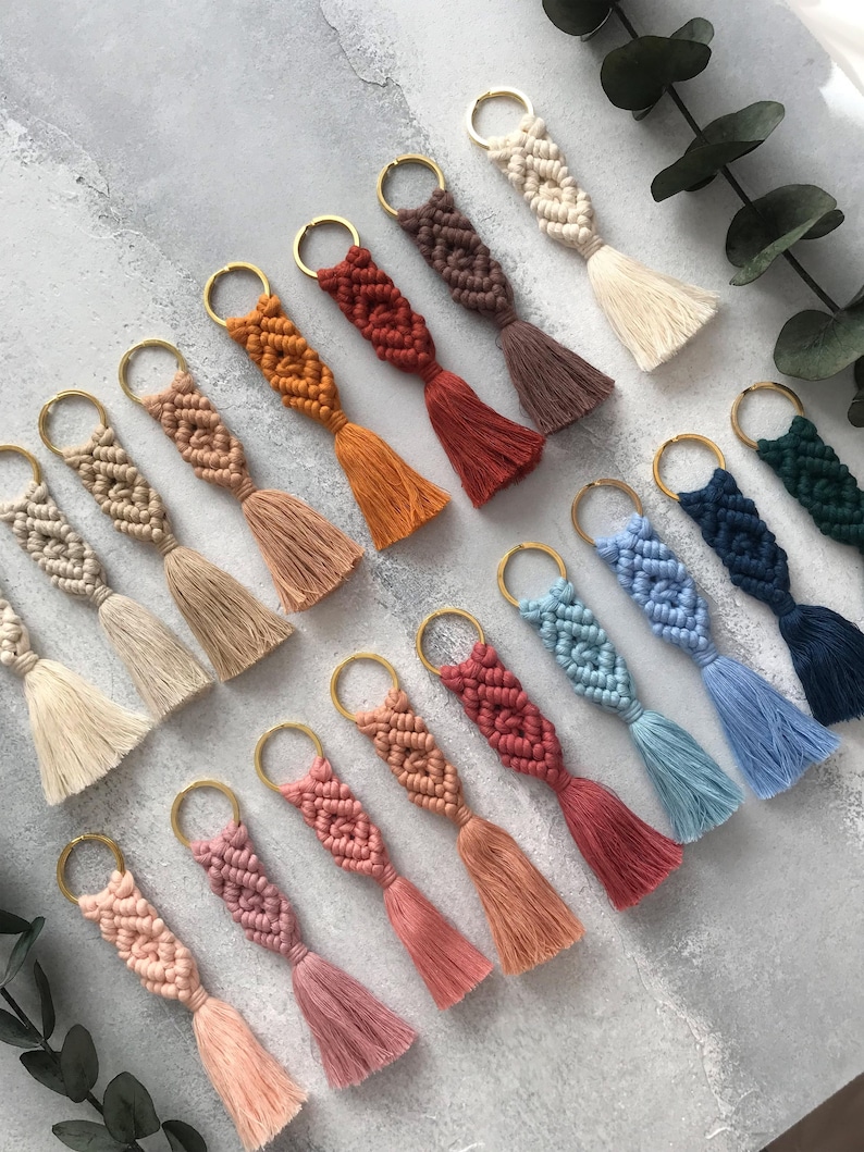 Personalized macramé keychains hand-woven from pure cotton cord. Available in a wide range of colors and featuring wooden bead accents, these keychains make a lovely gift for bridesmaids, the maid or matron of honor, flower girls, and the "bride tribe." They also add an elegant touch to bridesmaid proposal boxes.