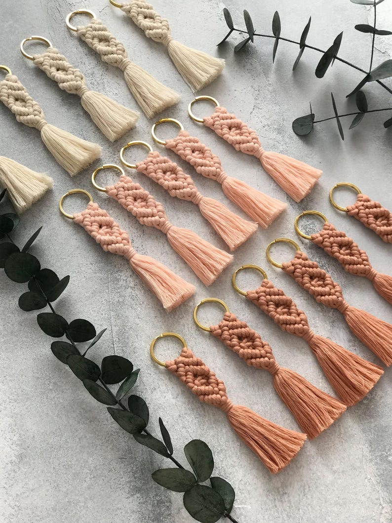 Personalized macramé keychains hand-woven from pure cotton cord. Available in a wide range of colors and featuring wooden bead accents, these keychains make a lovely gift for bridesmaids, the maid or matron of honor, flower girls, and the "bride tribe." They also add an elegant touch to bridesmaid proposal boxes.