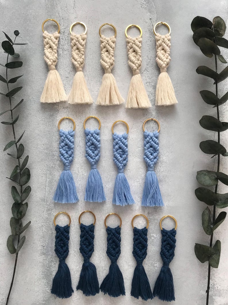 Personalized macramé keychains hand-woven from pure cotton cord. Available in a wide range of colors and featuring wooden bead accents, these keychains make a lovely gift for bridesmaids, the maid or matron of honor, flower girls, and the "bride tribe." They also add an elegant touch to bridesmaid proposal boxes.