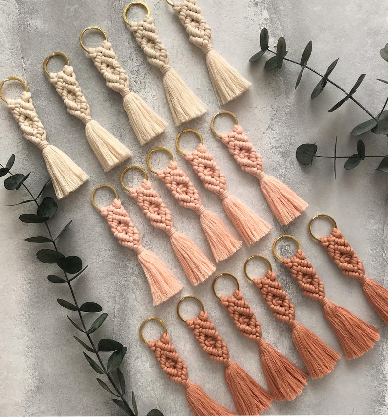 Personalized macramé keychains hand-woven from pure cotton cord. Available in a wide range of colors and featuring wooden bead accents, these keychains make a lovely gift for bridesmaids, the maid or matron of honor, flower girls, and the "bride tribe." They also add an elegant touch to bridesmaid proposal boxes.