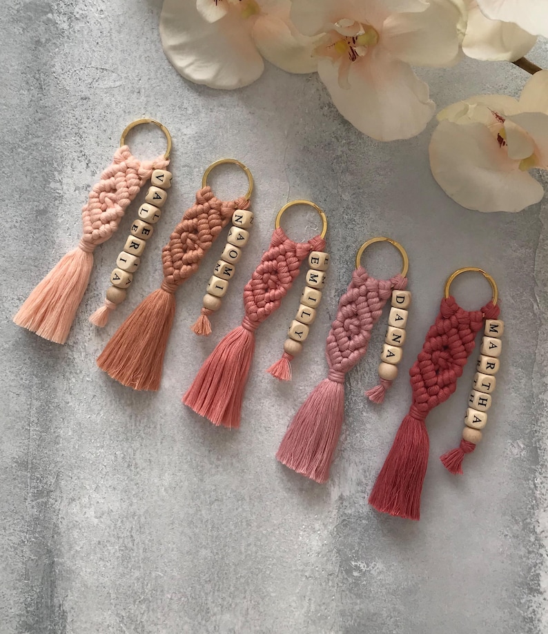 Personalized macramé keychains hand-woven from pure cotton cord. Available in a wide range of colors and featuring wooden bead accents, these keychains make a lovely gift for bridesmaids, the maid or matron of honor, flower girls, and the "bride tribe." They also add an elegant touch to bridesmaid proposal boxes.