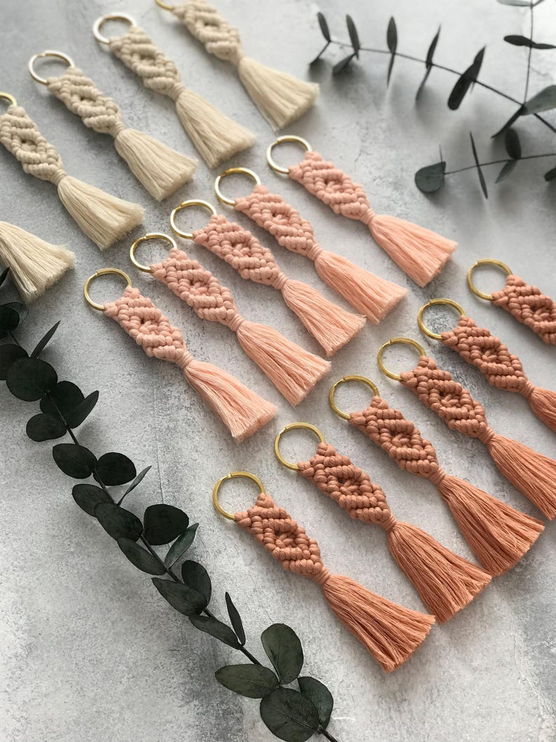 Personalized macramé keychains hand-woven from pure cotton cord. Available in a wide range of colors and featuring wooden bead accents, these keychains make a lovely gift for bridesmaids, the maid or matron of honor, flower girls, and the "bride tribe." They also add an elegant touch to bridesmaid proposal boxes.