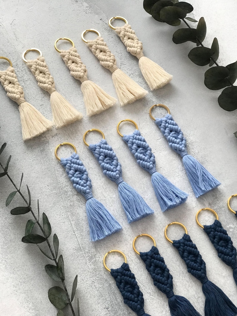 Personalized macramé keychains hand-woven from pure cotton cord. Available in a wide range of colors and featuring wooden bead accents, these keychains make a lovely gift for bridesmaids, the maid or matron of honor, flower girls, and the "bride tribe." They also add an elegant touch to bridesmaid proposal boxes.