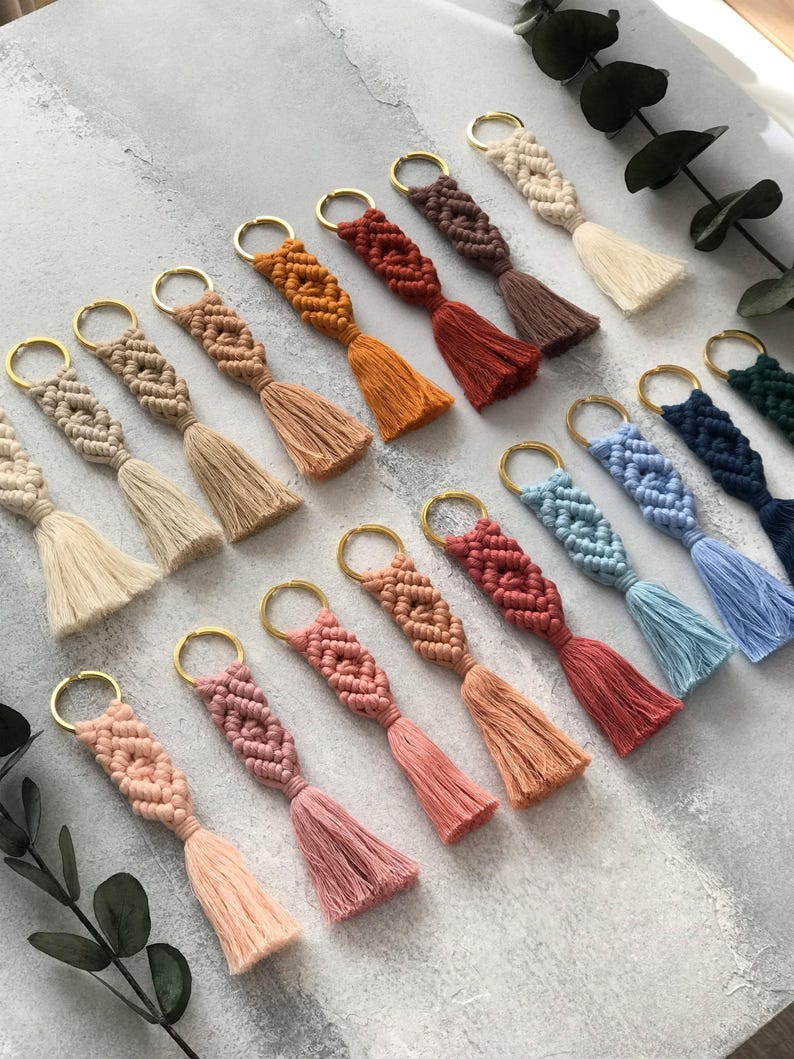 Personalized macramé keychains hand-woven from pure cotton cord. Available in a wide range of colors and featuring wooden bead accents, these keychains make a lovely gift for bridesmaids, the maid or matron of honor, flower girls, and the "bride tribe." They also add an elegant touch to bridesmaid proposal boxes.