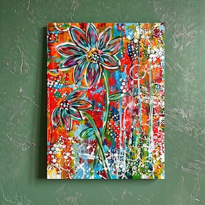 May include: A rectangular canvas painting featuring two stylized flowers with teal, purple, and dark blue petals. The background is a vibrant, abstract composition of red, orange, blue, and green paint splatters with white circular line patterns.