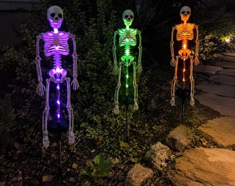 Lampada solare a forma di scheletro per il giardino, ideale per gli amanti di Halloween, decorazione spettrale per esterni con luce viola, verde o arancione.