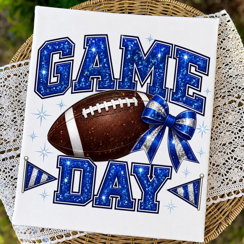 May include: A rectangular white canvas print featuring the text GAME DAY in large blue glitter letters. A brown football with white laces sits in the center, accented by a blue and silver striped bow and two small blue and silver pennant flags.