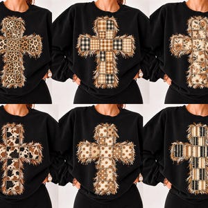 May include: A collection of six black crewneck sweatshirts, each featuring a large cross graphic on the chest. The crosses are composed of various patterned fabric patches, including leopard print, plaid, floral, cow print, and stripes, all with frayed edges.