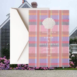 May include: A rectangular invitation card featuring a pink, orange, and light purple plaid pattern with a white embossed seashell icon at the top. The text reads: PLEASE JOIN US FOR DINNER & GOOD COMPANY AT OUR HOME AUGUST 2, 2026 5 PM. Includes envelope.