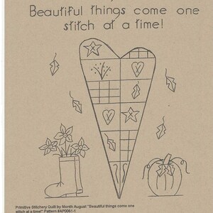 May include: A black and white line drawing of a heart-shaped quilt block with a variety of designs, including stars, hearts, and leaves. The quilt block is surrounded by other designs, including a pumpkin, a boot with flowers, and leaves. The text "August" and "Beautiful things come one stitch at a time!" is also included in the image.