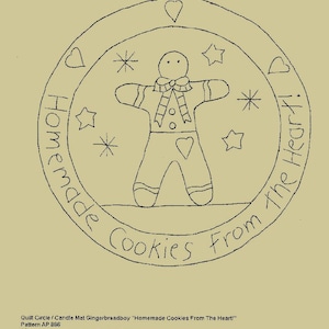 May include: Black and white line drawing of a gingerbread man with a heart on his chest, surrounded by stars and hearts. The drawing is in a circle with the text "Homemade Cookies From The Heart!" around the edge. The pattern is AP886 and measures 7 inches by 7 inches.