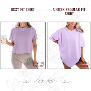 May include: Two light purple t-shirts from Comfort Colors. The left side shows a boxy fit shirt with a cropped length. The right side shows a unisex regular fit shirt with a longer, loose silhouette. Both shirts feature a crew neckline.