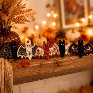 Cute crochet bat appliqués displayed on jute string, autumn home decoration, shallow depth of field, soft bokeh