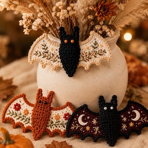 Handmade crochet Halloween bat garland, detailed yarn stitches, floral embroidery, warm golden light, rustic cozy styling