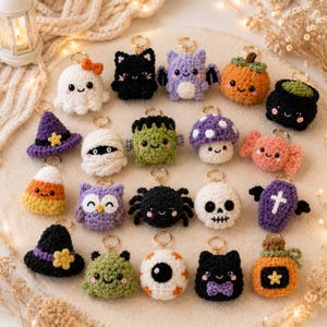 May include: A collection of twenty small, crocheted Halloween-themed keychains featuring various characters including a ghost, black cat, bat, pumpkin, cauldron, witch hat, mummy, Frankenstein, mushroom, candy, owl, spider, skull, coffin, and eyeball.