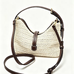 May include: A cream-colored woven straw handbag featuring dark brown leather trim, a central vertical strap with a buckle detail, and an adjustable dark brown leather shoulder strap with white stitching. The brand name NoviCarry is visible.