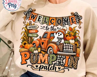 May include: A beige crewneck sweatshirt featuring a graphic of an orange truck, a ghost, pumpkins, and sunflowers. The text reads "WELCOME to the PUMPKIN patch" with "HAYRIDES", "CIDER", and "FALL FUN" on signs. The design includes plaid and leopard patterns.