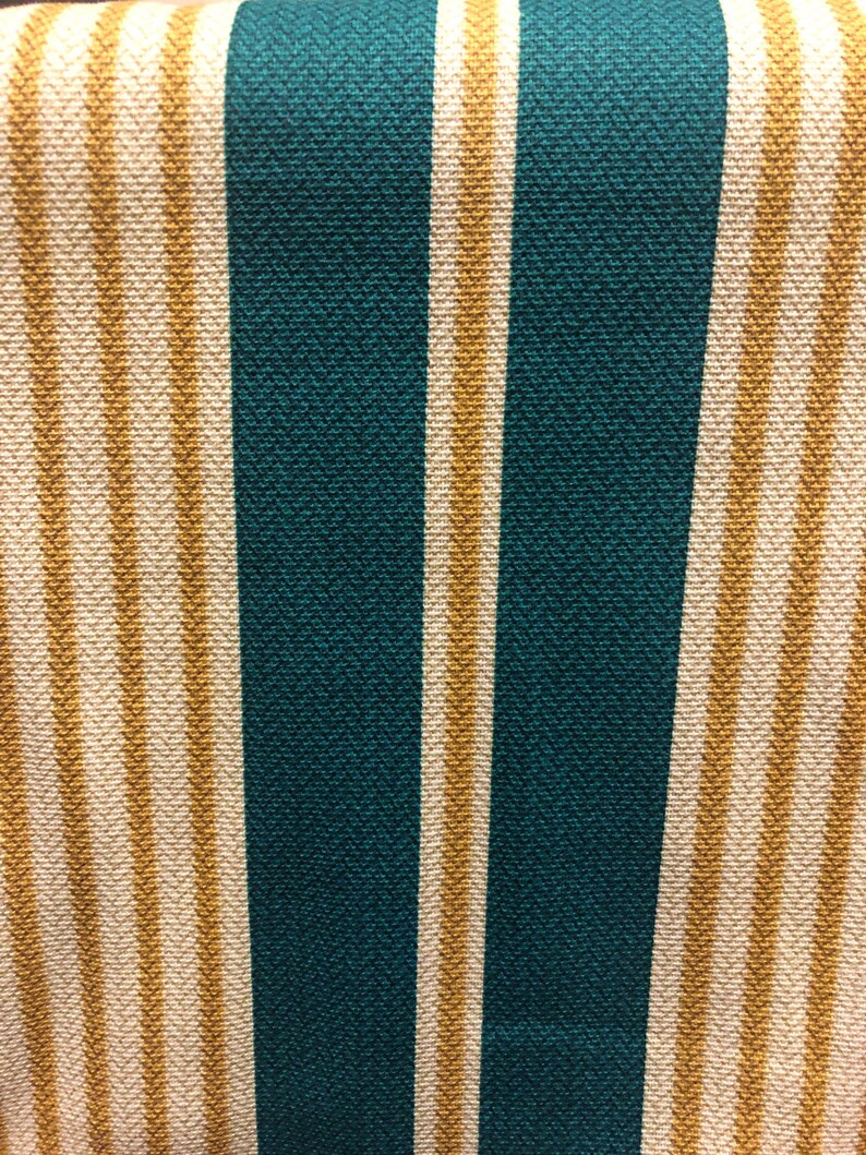 May include: Fabric with alternating stripes of teal and cream. The cream stripes have a subtle chevron pattern.