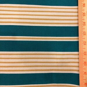 May include: Teal and beige striped fabric with a ruler measuring 18 inches.