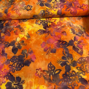 May include: Orange and purple floral fabric with a batik pattern. The fabric features a repeating pattern of hibiscus flowers.