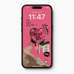 May include: A smartphone displaying a pink digital wallpaper featuring a central heart graphic with the text 'PROTECT YOUR PEACE'. Additional text includes 'NOT YOURS NEVER WAS' and 'XO', accompanied by a crown icon, lip print, and torn paper collage elements.