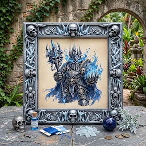 May include: A square framed artwork featuring a armored knight with a skull-topped mace and blue flames, surrounded by a frame decorated with skulls and ice shards. Nearby are a skull, a blue liquid bottle labeled Ice essence, and blue thread.