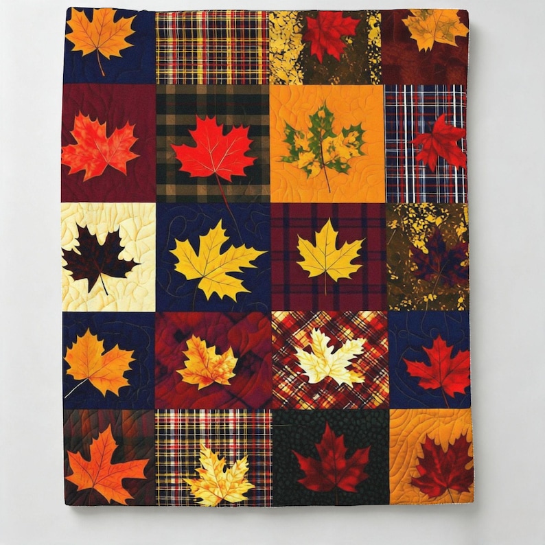 May include: A patchwork quilt featuring a grid of squares with alternating patterns of autumn maple leaves and various plaid or textured fabrics in shades of red, orange, yellow, brown, and navy blue, finished with visible machine quilting stitches.