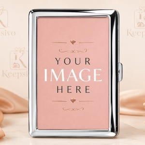 May include: A rectangular silver metal case with a polished finish. The front features a pink insert with the text "YOUR IMAGE HERE" in black and white lettering, accented by small heart icons and decorative flourishes above and below the text.