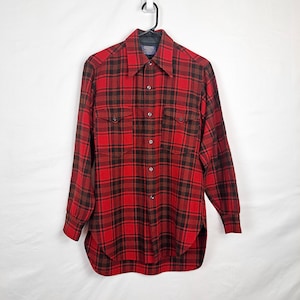 May include: A red and black plaid flannel shirt with a button-down collar and long sleeves.