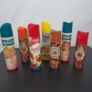 May include: Eight different air freshener spray bottles. The bottles are all different colors and have different designs. The brands include Glade, Renuzit, and Potpourri. The scents include Citrus Sunburst, Peach Blossom, Strawberry & Cream, Orchard Spice, Cinnamon Sticks, Tropical Mist, and Sunsplash.