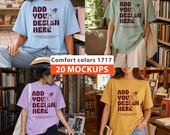 May include: A collection of four short-sleeve t-shirts in light blue, sage green, lavender, and mustard yellow. Each shirt features a dark maroon graphic of a person sitting and the text ADD YOU DESIGN HERE with smaller text underneath.