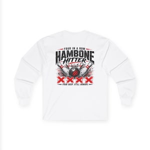 May include: A white long-sleeve shirt featuring a graphic on the back with the text "FOUR IN A ROW HAMBONE HITTER" and "FOUR DEEP. STILL HUNGRY." The design includes a black bowling ball, white bowling pins, and four large red X symbols.
