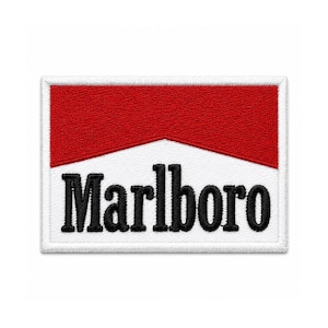 May include: A rectangular embroidered patch featuring a horizontal design with a solid red upper section and a white lower section. The word Marlboro is stitched in bold black lettering across the white portion, framed by a white border.