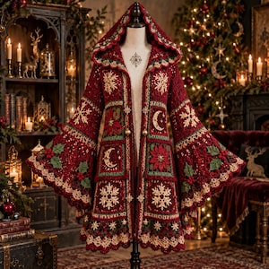 May include: A long-sleeved, hooded crochet cardigan in deep red, featuring intricate square panels with cream-colored snowflake and crescent moon motifs, alongside green and red poinsettia and holly leaf patterns, finished with a scalloped cream border.