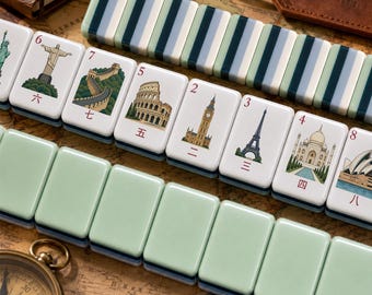May include: A set of rectangular mahjong tiles featuring illustrations of global landmarks including the Statue of Liberty, Christ the Redeemer, the Great Wall, the Colosseum, Big Ben, the Eiffel Tower, the Taj Mahal, and the Sydney Opera House.