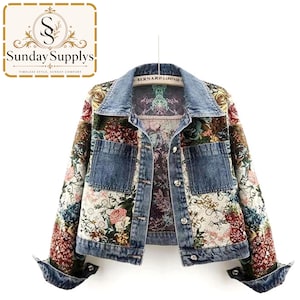 May include: A denim jacket featuring a multi-colored floral tapestry pattern on the front panels and sleeves. The jacket includes a classic collar, two chest pockets, and silver-toned metal buttons. The interior label reads Bernard Lafon.