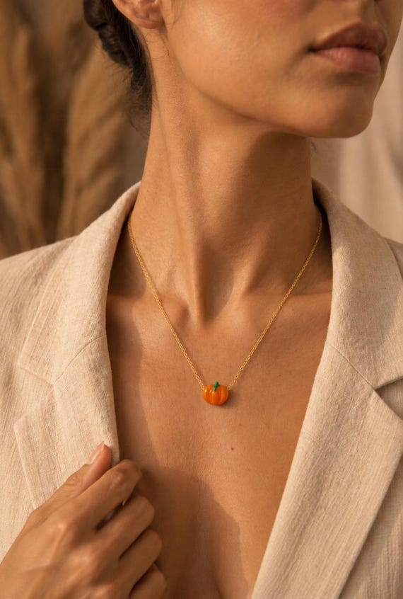 18 Halloween Accessories for a Little Everyday Spookiness 14 Glass Pumpkin Necklace