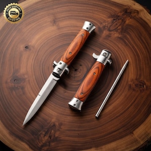 May include: A folding knife with a silver blade and a brown wood grain handle, a second closed folding knife with a matching wood grain handle, and a thin silver metal rod. The knives feature silver metal bolsters and visible screw fasteners.