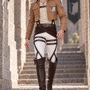 May include: A tan cropped jacket with a blue and white wing emblem, a beige lace-up shirt, a dark brown waist wrap, white trousers, and dark brown leather thigh-high boots with a complex system of brown buckled straps worn over the legs.