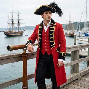 May include: A red long coat with black lapels and gold buttons, a white collared shirt, black trousers, and a black tricorn hat with a feather plume. The outfit is worn with black boots, creating a historical naval-inspired ensemble.