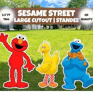 May include: A Sesame Street large cutout standee featuring Elmo, Big Bird, and Cookie Monster. The text reads SESAME STREET LARGE CUTOUT | STANDEE, 5.5' FT TALL, HD QUALITY. Elmo is red, Big Bird is yellow, and Cookie Monster is blue holding cookies.