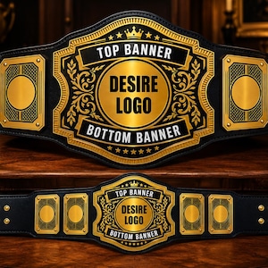Könnte beinhalten: Ein schwarzer Meisterschaftsgürtel mit einer großen, goldenen Mittelplatte, verziert mit Ornamenten, einem Kronensymbol und dem Text TOP BANNER, DESIRE LOGO und BOTTOM BANNER. Der Gürtel hat seitliche Goldplatten und goldene Nieten.