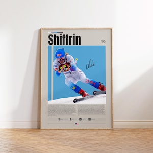 May include: A vertical poster featuring a skier in a white and blue racing suit with a blue helmet and goggles. The text reads Shiffrin /95. The skier is in a crouched position on snow. Below the image is a biography and statistics including 15 World Championships, 3 Olympic medals, 104 World Cup wins, and 160 World Cup podiums.