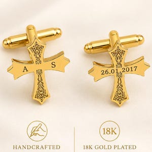 May include: A pair of gold-toned metal cufflinks featuring a cross-shaped design with intricate filigree patterns. One cufflink is engraved with the letters A and S, while the other displays the date 26.01.2017. The text WEDDING CUFFLINKS is visible.