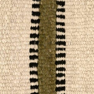 Hand woven wool area rug in cream, olive green, and black with a modern striped pattern, featuring a textured flatweave design and neutral colors, shown in close-up and contemporary living room settings. Handmade minimalist rug for living room, bedroom, office, or entryway decor.